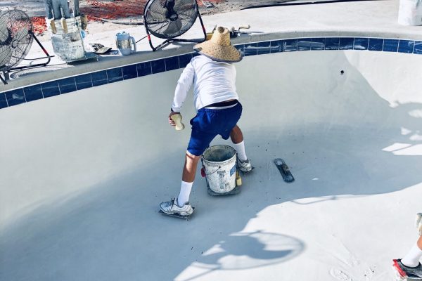 worker-putting-the-finishing-touches-to-the-pool-2024-11-25-18-14-58-utc